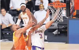  ?? KIM KLEMENT, POOL/ASSOCIATED PRESS ?? Anthony Davis of the Lakers is fouled by Utah’s Rudy Gobert on Monday night. Los Angeles got 42 points from Davis in a 116-108 victory.