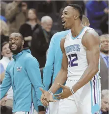  ?? STAFF PHOTO BY ?? CREATING SOME BUZZ: Dwight Howard reacts after making two free throws during last night’s victory against the Wizards in Charlotte, N.C.