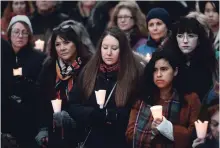  ?? JUSTIN TANG THE CANADIAN PRESS ?? People hold candles during a vigil against anti-Semitism and white supremacy on Sunday at the Human Rights Monument in Ottawa.