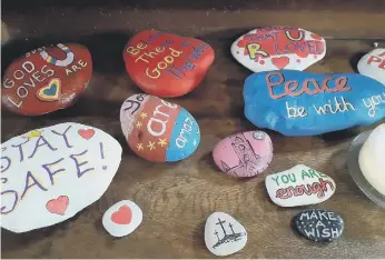  ??  ?? Decorated stones on display at Sunderland Minster sharing messages of safety and prayer.