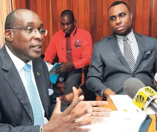  ?? LIONEL ROOKWOOD/PHOTOGRAPH­ER ?? Education Minister Ruel Reid addresses journalist at a press conference held at the Ministry of Education yesterday. Looking on is Permanent Secretary in the Ministry of Education Deanroy Bernard.