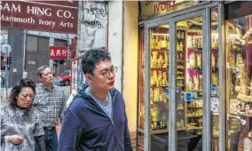  ??  ?? An ivory shop on Queens Road in Sheung Wan. Some conservati­onists argue that the legal trade in stockpiled ivory has helped obscure a vast illegal market.