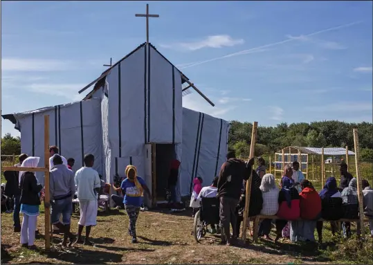  ??  ?? Oh come, all ye faithful: Ethiopian and Eritrean worshipper­s at the makeshift chapel from which the programme will be broadcast