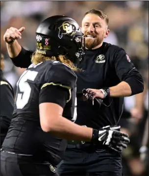  ?? CLIFF GRASSMICK — DAILY CAMERA ?? Colorado interim head coach Mike Sanford celebrates with Tommy Brown after a touchdown against the Arizona State Sun Devils last month.