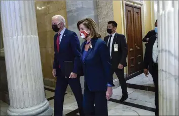  ?? SUSAN WALSH — THE ASSOCIATED PRESS ?? President Joe Biden walks with House Speaker Nancy Pelosi on Capitol Hill in Washington on Friday for a meeting with the House Democratic caucus.