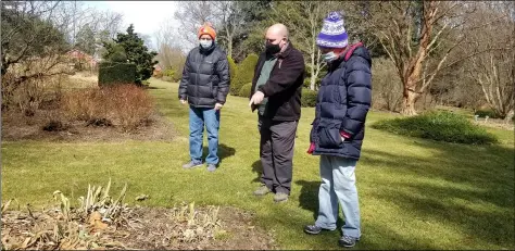  ?? PHOTOS BY JORDANA JOY - THE MORNING JOURNAL ?? Matt Kocsis, senior naturalist at Lorain County Metro Parks, center, speaks with Burt Vilagi, 56, left, and Michelle Vilagi, 55, both of North Ridgeville, on March 13during a First Flowers Walk at Schoepfle Gardens, 11106Marke­t St. in Birmingham.