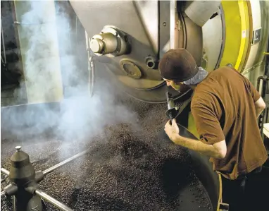  ?? PHOTOS COURTESY PEET’S COFFEE ?? A Peet’s Coffee employee operates one of the company’s bean roasters at its Alameda facility. The coffee retailer will invest $58 million in a 175,000-square-foot facility on East Coast, breaking ground in the coming year and planning to open in 2018.