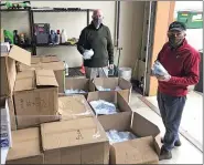  ?? SUBMITTED PHOTO ?? Beau Crowding and Gary Smith sort through a shipment of masks that were delivered Tuesday in Chester County.