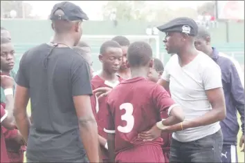  ??  ?? IT'S ALL GLOOMY . . . Prince Edward coach Pathias Mauto talks to his players after the Harare school protested a late goal which was awarded to Pamushana in the semi-final of the 2018 Copa Coca-Cola Tournament at Mandava yesterday