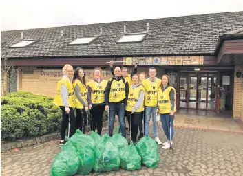  ??  ?? Team effort McDonald’s staff collected 11 bags of litter on their six-mile walk to the Coatbridge park