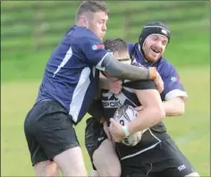  ??  ?? Laurence Steen is tackled by two Kilkenny players.