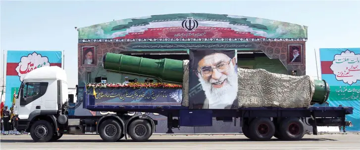  ??  ?? A TRUCK carrying a missile and a picture of Iran’s Supreme Leader Ayatollah Ali Khamenei is seen during a 2015 Tehran parade marking the anniversar­y of the 1980-88 Iran-Iraq war.