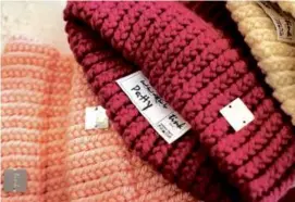  ?? ?? The names of the Providence-area women who knitted hats through the Tink Knit program are written on tags.