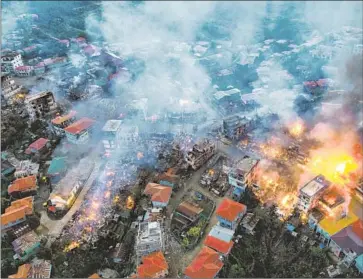  ?? AFP/Getty Images ?? THANTLANG, Myanmar, in an aerial image after military shelling in October 2021. More than 7,000 civilians have been killed since the military launched its February 2021 coup, the Institute for Strategy and Policy says.