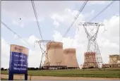  ?? PICTURE: NADINE HUTTON/BLOOMBERG ?? Electricit­y power lines and cooling towers are seen at Eskom’s Kendal coal-fired power station in Delmas. Eskom did not get good press this year.