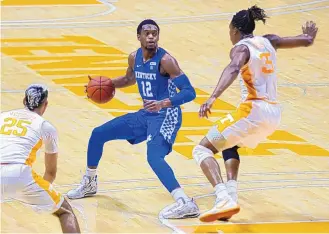  ?? RANDY SARTIN/ASSOCIATED PRESS POOL PHOTO ?? Kentucky’s Keion Brooks Jr. (12) brings up the ball against Tennessee’s Yves Pons (35) and Santiago Vescovi (25). The Wildcats are only 8-13, but dominated the No. 19 Vols on Saturday in Knoxville.