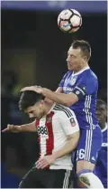  ??  ?? LONDON: Chelsea’s John Terry, top, challenges for the ball with Brentford’s Scott Hogan during the English FA Cup soccer match between Chelsea and Brentford at Stamford Bridge stadium in London, yesterday. — AP