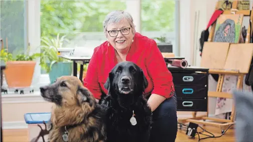  ?? BOB TYMCZYSZYN THE ST. CATHARINES STANDARD ?? Jan Handy with her dogs, Shyla and Quincy. Handy is the executive director of the Kristen French Child Advocacy Centre Niagara, in St. Catharines. She has published a book, The Secret Tribe, about her personal journey as an abused child — and the resilience that grew from that experience.