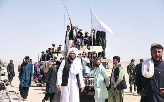  ?? JAVED TANVEER/AFP/GETTY IMAGES ?? Taliban and Afghan security forces celebrated a historic Eid ceasefire in June in Kandahar, a signal fighters on both sides are fed up with the conflict.
