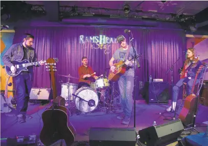  ?? PHOTOS BY PAUL W. GILLESPIE/CAPITAL GAZETTE ?? Jackson Dean, center right, warms up with the band, from left, Brandon Aksteter, guitar; Sean Mercer, drums; and Rich Kohlm, bass, during a preshow soundcheck at Rams Head On Stage in Annapolis on Saturday.