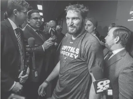  ?? ERNEST DOROSZUK ?? Washington Capitals left wing Alex Ovechkin squeezes past reporters Tuesday at the Air Canada Centre in Toronto. Asked if he still intends to play in the PyeongChan­g Olympics after the NHL ruled out sending its players to the Games, Ovechkin said, “In...