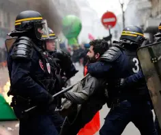  ?? Photo: Christophe Ena ?? PENSION PROTESTS: French riot police grab a protester during a rail workers’ march in Paris last week.