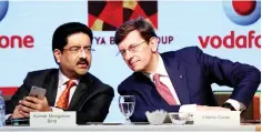  ??  ?? Kumar Mangalam Birla (left), chairman of Aditya Birla Group, speaks to Vittorio Colao, CEO of Vodafone Group, during a news conference in Mumbai, India March 20. — Reuters photo