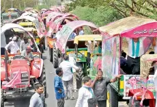  ?? — DECCAN CHRONICLE ?? TRS leaders and workers reach the public meeting venue in tractors decorated in party colours on Thursday.