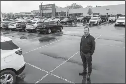  ?? RYAN GARZA/DETROIT FREE PRESS/TNS ?? Matick Chevrolet Vice President and Owner Paul Zimmermann stands in an empty row amongst other spaces where new vehicles would be parked in a lot at Matick Chevrolet in Redford, Mich., on May 3.