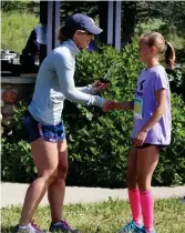  ??  ?? Jadyn Palaschuk of Moose Jaw collects her award for second fastest time in the women’s 5K