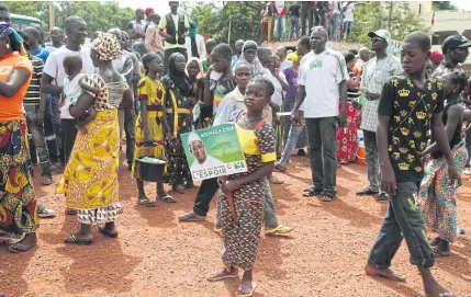  ?? AP ?? A young supporter of Soumaila Cisse, Opposition Presidenti­al aspirant candidate of the Union for the Republic and Democracy party, holds a banner with his image, during an election campaign rally in Yanfolila, Mali. As deadly attacks by extremists become more brazen in Mali, officials and citizens fear this month’s presidenti­al election will be at risk from growing insecurity.