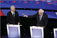  ?? PATRICK SEMANSKY ?? Democratic presidenti­al candidate former Vice President Joe Biden, left, watches as Sen. Bernie Sanders, I-Vt., answers a question Tuesday, Jan. 14, 2020, during a Democratic presidenti­al primary debate hosted by CNN and the Des Moines Register in Des Moines, Iowa.