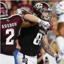  ?? Godofredo A. Vasquez / Staff photograph­er ?? Jace Sternberge­r, right, scored two touchdowns in his first game playing tight end for Texas A&amp;M.