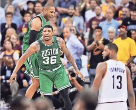  ?? KEN BLAZE / USA TODAY SPORTS ?? Marcus Smart (36) and Al Horford celebrate after the Celtics won on Avery Bradley’s last-second shot against the Cavaliers in Game 3 of the Eastern Conference finals.