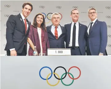  ??  ?? (From left) Paris 2024 Co-Chairman Tony Estanguet, Paris Mayor Anne Hidalgo, Thomas Bach, Eric Garcetti and LA2028 Chairman Casey Wasserman pose for pictures after delivering a press message during the 131st Internatio­nal Olympic Committee (IOC)...