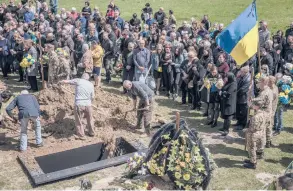  ?? FINBARR O’REILLY/THE NEW YORK TIMES ?? Mourners attend the funeral of Ukrainian soldier Malevskyi Oleksandr on Friday in Lviv, Ukraine. Oleksandr was killed during fighting in the country’s east.