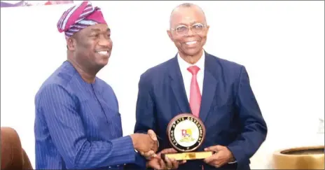  ?? PHOTO: SUNDAY AKINLOLU ?? Lagos State Deputy Governor, Dr. Kadri Obafemi Hamzat( left), presents a souvenir to the President of Lagos Chamber of Commerce and Industry ( LCCI), Gabriel Idahosa, during a courtesy visit of LCCI to the Deputy Governor.