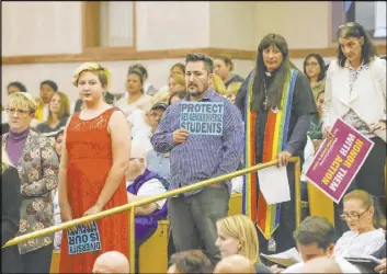  ??  ?? Members of the audience line up for public comment about an agenda item on whether or not to direct a gender-diverse policy for the school district.