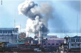  ??  ?? AN EXPLOSION is seen on June 27 after a Philippine army aircraft released a bomb during an air strike as government troops continue their assault against insurgents from the Maute group in Marawi City.