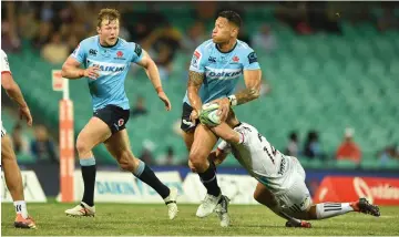  ??  ?? Waratahs player Israel Folau (centre) is tackled by Crusaders player Ryan Crotty (right) as Waratahs teamate Nick Phipps (left) looks on during the Super15’s rugby match between Australa’s Waratahs and New Zealand’s Crusaders at the Sydney Cricket Ground in Sydney. — AFP photo