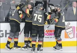  ?? Ethan Miller Getty Images ?? TEAMMATES congratula­te Tomas Nosek (92) after his second-period goal gave Vegas a 2-1 lead. Moments earlier, Nosek’s blunder led to a Winnipeg goal.