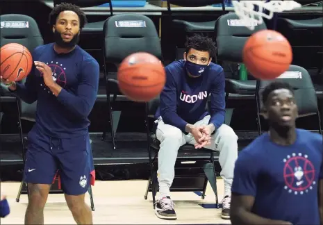  ?? David Butler II / Associated Press ?? UConn’s James Bouknight, middle, looks on from the sideline as his teammates warm up before Tuesday’s game against Butler.