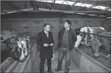  ?? WANG QUANCHAO / XINHUA ?? A beef cattle farmer (right) talks to a bank clerk about his business and funding needs in Chongqing on Jan 20.