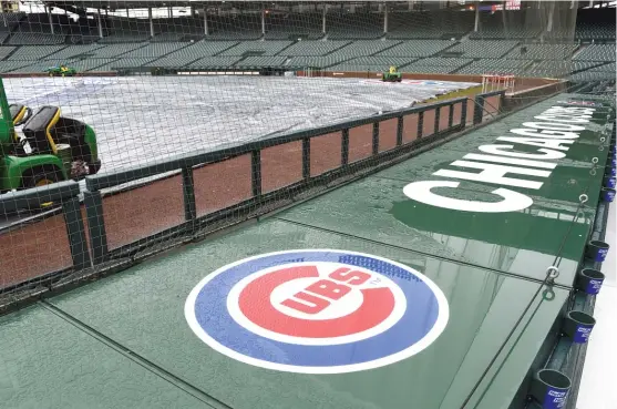  ??  ?? Persistent rain and a dire forecast forced the Cubs’ game Sunday against the Braves atWrigley Field to be postponed. It was reschedule­d for May 14. MATTMARTON/ AP