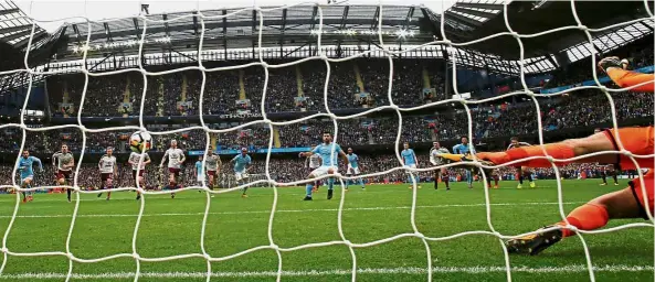  ??  ?? Spot on: Manchester City’s Sergio Aguero sending Burnley goalkeeper Nick Pope the wrong way to score his 177th goal for the club. — Reuters