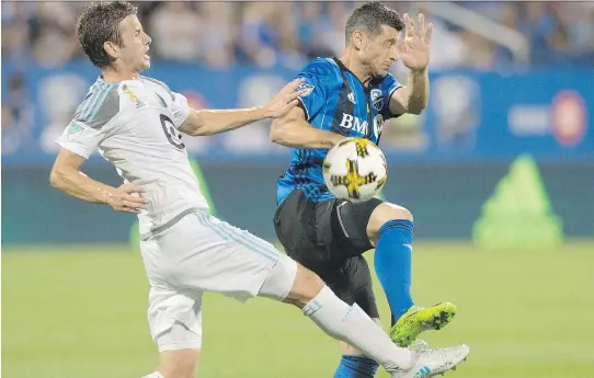  ?? GRAHAM HUGHES/THE CANADIAN PRESS ?? Montreal Impact’s Blerim Dzemaili, right, challenges Minnesota United FC’s Collin Martin in Montreal on Saturday. Minnesota won 3-2.