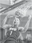  ?? Brandon Wade / Tribune News Service ?? With Desmond Bane contributi­ng this dunk and much more, TCU flexed its muscles against West Virginia.