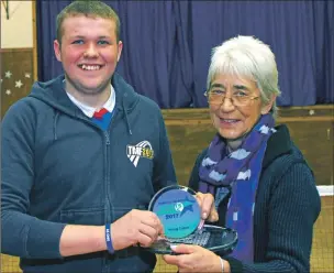  ?? Photograph: Kevin McGlynn. ?? Michael Strathern receives his sports award from councillor Elaine Robertson at Benderloch Badminton Club.