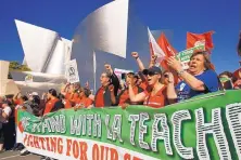  ?? DAMIAN DOVARGANES/ASSOCIATED PRESS ?? United Teachers Los Angeles leaders are joined by thousands of teachers, who may go on strike next month, as they march in downtown Los Angeles on Saturday.