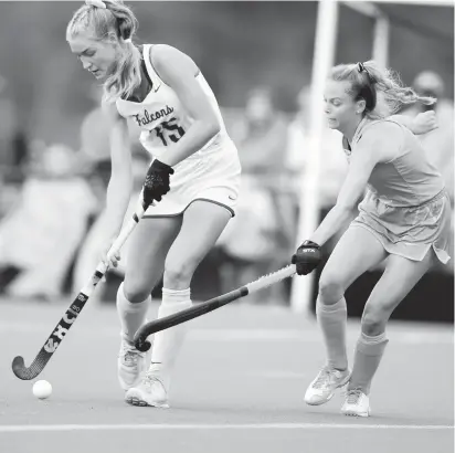  ?? COURTESY OF JOHN RADD ?? Cox’s Emme Schwartz advances the ball during a first-round Class 5 Region A field hockey game Monday at the Regional Training Center in Virginia Beach. The Falcons ousted First Colonial 1-0 in a clash of state powers.